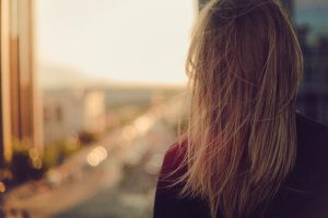 woman looking out of window