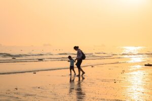child on beach with parent